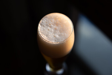Cold beer on reflective glass table