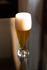 Cold beer on reflective glass table