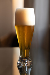 Cold beer on reflective glass table