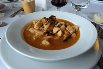 Close up bowl of Arroz Caldoso, Spanish rice soup with chicken and seafood