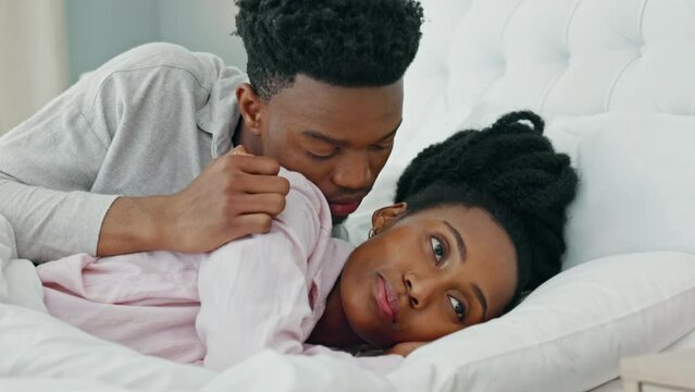 Relationship problems, upset and unhappy woman ignoring man after arguing, cheating or pms while lying in bed. Black couple feeling sad or depressed about marriage or relationship issues or trouble