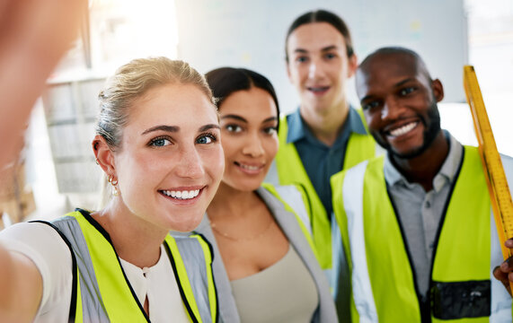 Group of industrial staff taking a selfie on a phone while working in a warehouse factory. Portrait of industry engineers taking picture in office while planning project at work site.