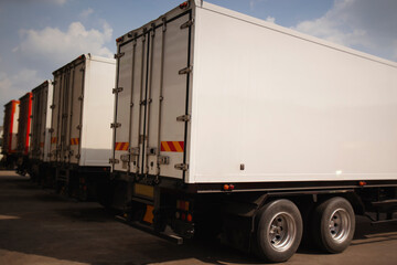 Obraz na płótnie Canvas Shipping Cargo Containers. Semi Trailer Trucks on Parking. Shipping Truck. Delivery Transit. Industry Freight Trucks Logistics Cargo Transport. 