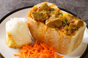 traditional durban mutton bunny chow closeup on plate on the table. Horizontal - obrazy, fototapety, plakaty