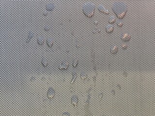 Water drops on a gray woven surface