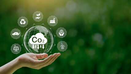 Reduce CO2 emission concept in the hand with icons, global warming for environmental.Net zero and carbon neutral concept.