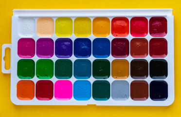 Watercolor paint set in plastic box. Top view.