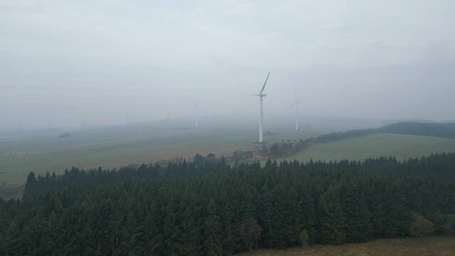 Morning fog over a wind farm in the mountains. Largest wind power plant in the Czech Republic. Krystofovy Hamry