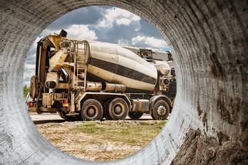 Concrete mixer truck in front of a concrete batching plant, cement factory. Loading concrete mixer truck. Close-up. Delivery of concrete to the construction site. Monolithic concrete works.
