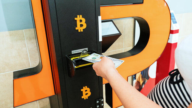 Atm cash bitcoin teller machine. Woman withdraw american dollar bill money. Usd hundred money payment on virtual crypto currency btc wallet. Bitcoin BTC ATM Cash Machine.
