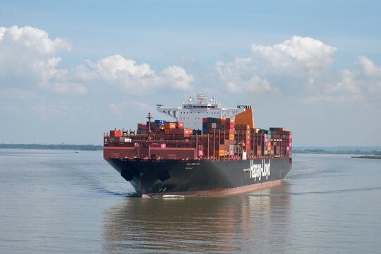 German shipping company owned container vessel underway on Elbe river