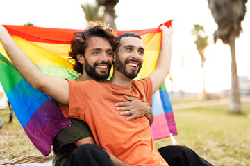  Happy couple with a pride flag. LGBT community.