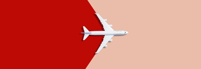 Flat lay design of travel concept with plane on pink red runway back © Angelov
