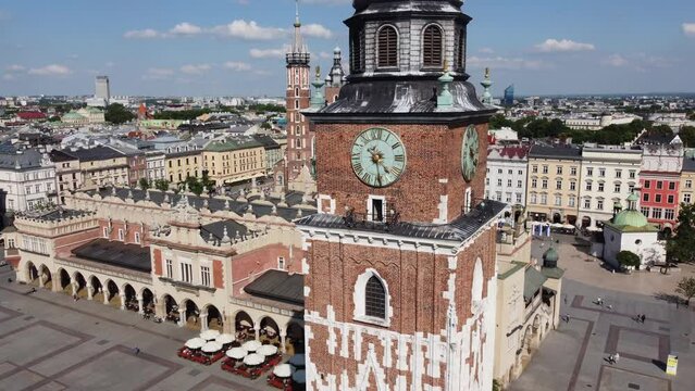 Town Hall Tower (Wieża Ratuszowa) in the main square  - City Centre flyover of Krakow, Poland, a Polish cultural capital, with medieval and renaissance architecture - 4K 30FPS Smooth Tracking Right