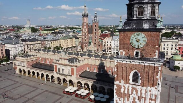 The Cloth Hall (Sukiennice) Market and St. Mary's Basilica (Bazylika Mariacka) in the City Centre of Krakow, Poland, a Polish cultural capital with renaissance architecture - 4K 30FPS Static