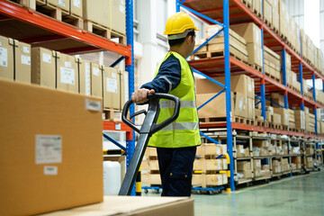 Warehouse worker pull pallet truck after inspects goods in inventory and check stock product. Transport logistic business shipping and delivery to customers through a freight forwarding company. © Shisu_ka