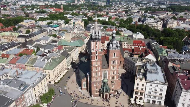 St. Mary's Basilica (Bazylika Mariacka), Clock Tower at the Main Square in Krakow, Poland, a Polish cultural capital, with medieval and renaissance architecture - 4K 30FPS Smooth Tracking Left