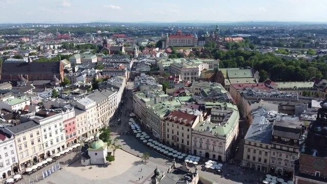 View of Wawel Royal Castle Cathedral from the Main Square - City Centre flyover of Krakow, Poland, a Polish cultural capital, with medieval and renaissance architecture - 4K 30FPS Tracking Forwards