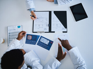 Doctor, research paper and finance planning in meeting, collaboration or teamwork strategy with science cure paper. Top view, hands or healthcare data for medical workers searching insurance funding
