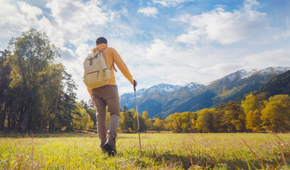 trip to Caucasus mountains, Arkhyz, Teberdinsky reserve. concept of discovery and exploration of wild places in early autumn. Man hiking in mountains with backpack and photo camera