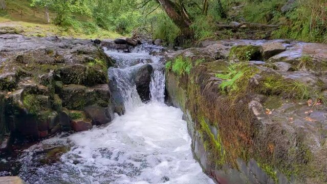 Slow Motion of Small Waterfall at Sgwd Clun-Gwyn in Brecon Beacons Wales UK