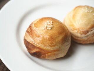 Chinese sweet flaky puff pastry with mung bean paste filling on white plate