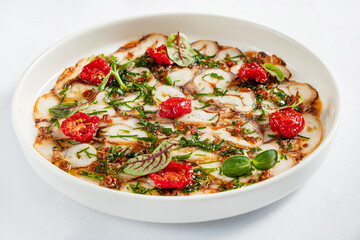octopus carpaccio with tomato and herb