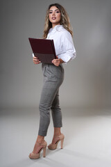 Young businesswoman with documents on gray