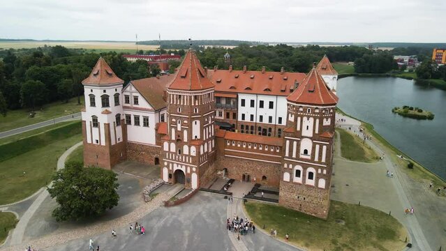 Ascending aerial footage of the mir castle in mir city belarus on an overcast day