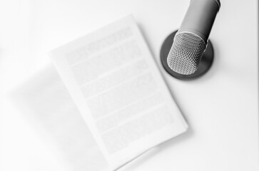 Professional microphone and text on paper