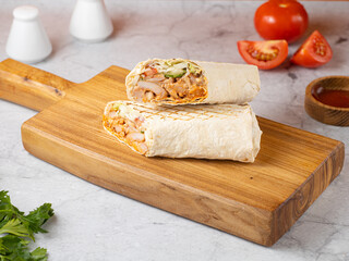 Delicious shawarma sandwich on light wooden background. Copy space