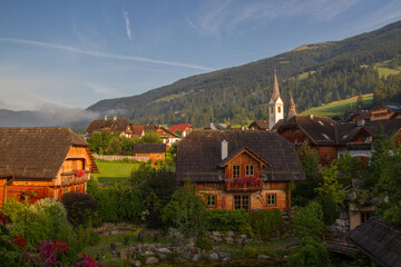 Village of Sankt Michael im Lungau, Salzburger Land, Austria, at sunset, with mountains in the background, summer
