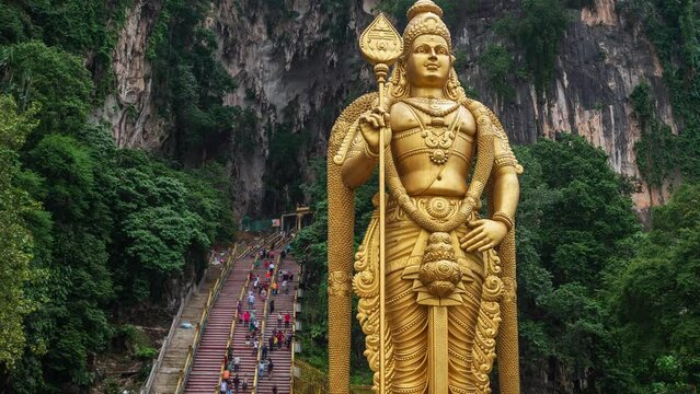 Time lapse view of the entrance to the ancient Batu Caves near Kuala Lumpur, Malaysia, one of the most important Hindu shrines outside of India, dedicated to Lord Murugan.	
