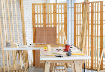 Wood working table in interior housing construction site with nobody full of equipment and tools,...