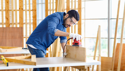 Indian Asian professional engineer architect foreman labor worker wears safety goggles glasses and...