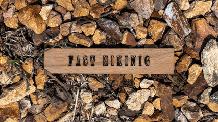 Fast hiking written on wooden surface. Background stone pattern created.