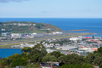 Fototapeta na wymiar Wellington International Airport runway surrounded by water ocean and residential houses in Capital Wellington, New Zealand Aotearoa
