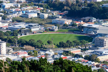 Fototapeta na wymiar A view of Wellington Basin sporting cricket grounds with perfectly mowed lawn surrounded by offices and houses in the Capital Wellington, New Zealand Aotearoa