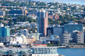 Fototapeta na wymiar A view of Wellington's harbour and waterfront with office buildings, apartments and houses in the Capital city Wellington, New Zealand Aotearoa