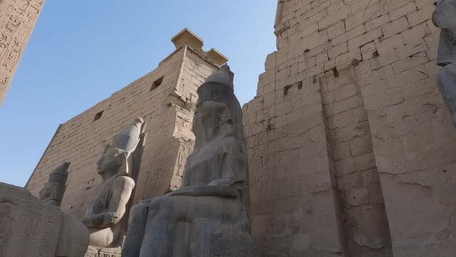 Low Angle Looking Up At Seated Statues At Karnak Temple In Luxor. Pan Down