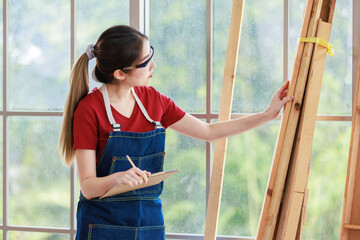 Asian professional female engineer architect foreman labor worker wears safety goggles glasses and...
