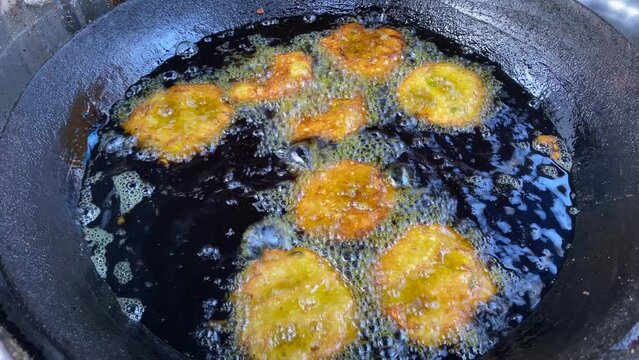 Moong Dal Pakoda, also known as Moong Dal Bhajiya or Moong Dal Vada, is fried in hot oil and served on the streets of Kolkata, West Bengal.
