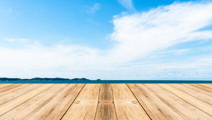 Wooden table for a picnic and a beautiful sea with blue sky background