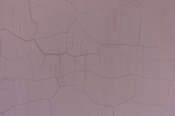 Close shot of cracked brownish pink painted wall