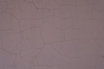 Texture of cracked brownish pink painted wall