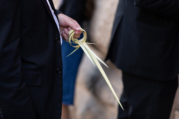 Strands of palm frond are woven into decorative rings used to bind the lulav used in the ritual...