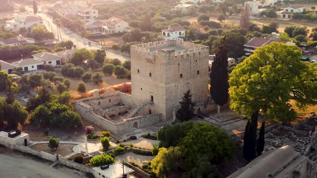 Aerial drone 360 orbit close up footage of medieval castle of Kolossi, south of Cyprus, in Limassol from above, at sunset. The castle dates back to the crusades and is a landmark of the area.