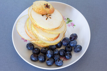 delicious split pears with blueberries on a plate