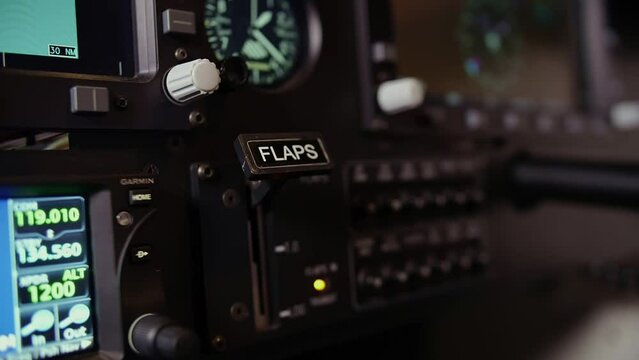Cockpit indicators.training in flight simulator.pilot's hand presses open flaps