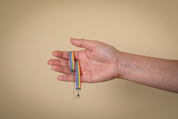 Colorful rainbow bracelet. Woman's hand and fingers